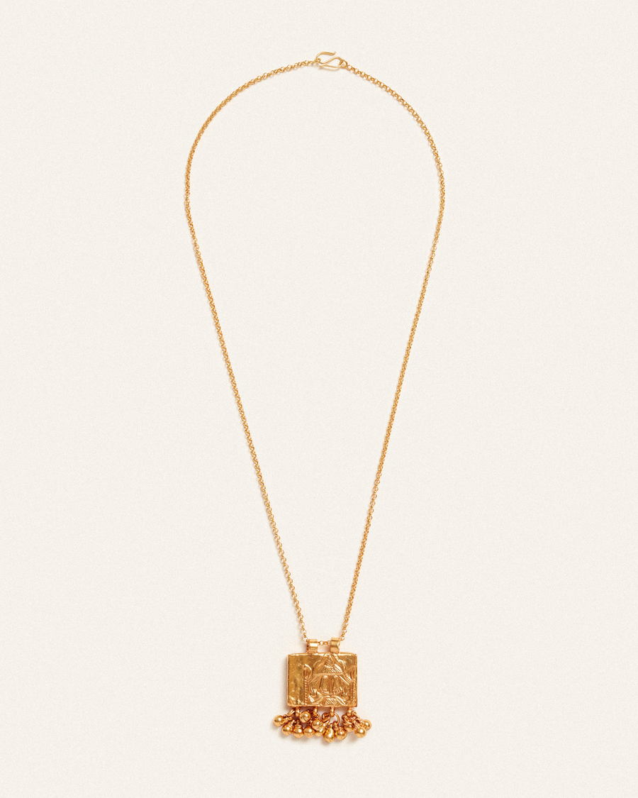 Grounded antique gold pendant with tassels